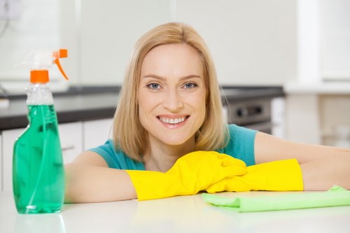Staff using approved cleaning products with proper protective measures