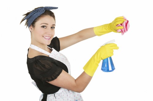 Cleaner wearing PPE while carrying out carpet cleaning in a home